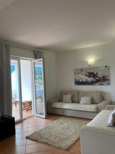 a living room with a couch and a view of the ocean at Casa di Giorgio in Jelsa