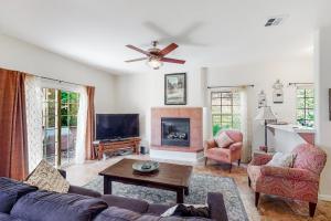 a living room with a couch and a fireplace at Willard Lake House in Bass Lake