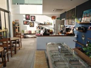 a restaurant with a counter and tables and chairs at Embassy gardens Luxury suites CPG in Accra