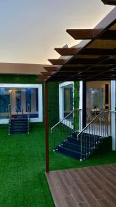a room with green grass and stairs in a building at جنة الطائف in Taif