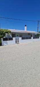 a white house with a lighthouse on top of it at Livadi house in Theologos