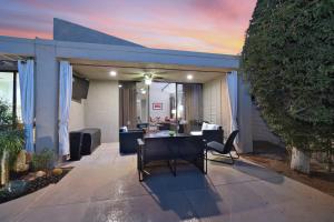 a house with a patio with a table and chairs at Sundance Villa Condo E Permit# 2845 in Palm Springs