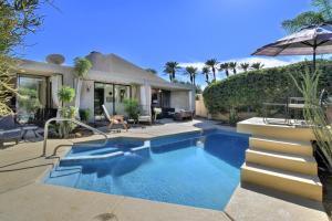 a swimming pool in the backyard of a house at Sundance Villa Condo E Permit# 2845 in Palm Springs