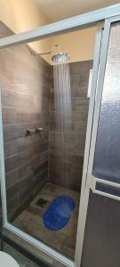 a shower with a glass door with a shower head at super condo with fiber optic internet in Puerto Peñasco +12 photos
