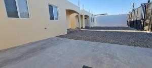 an empty sidewalk next to a white building at super condo with fiber optic internet in Puerto Peñasco