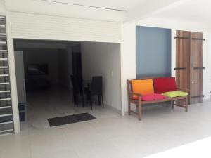 a living room with a couch and a table at JONA APT in Le Lamentin