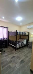 two bunk beds in a room with a desk at super condo with fiber optic internet in Puerto Peñasco