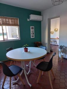 a table and chairs in a room with a green wall at Departamento San Lorenzo para 4 personas in Mendoza