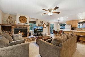 a living room with two couches and a fireplace at Atroari Adventures in South Lake Tahoe