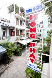 a sign for a hotel in front of a building at Hồng Phát Hostel in Hue