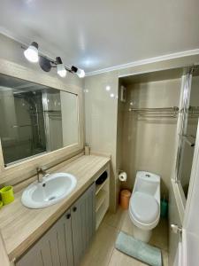 a bathroom with a sink and a toilet and a mirror at Puerto Velero/ Primera Linea in Puerto Velero +66 photos
