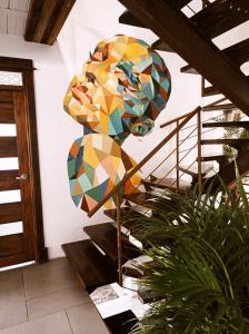 a staircase with a mosaic art on the wall at Casa NATIVO in Jardin