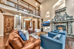 a living room with two couches and a stone fireplace at Cochise Charms in South Lake Tahoe