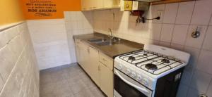 a small kitchen with a stove and a sink at Tomay Apart in Santa Fe