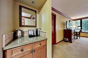 a kitchen with a counter with a sink and a mirror at Resort at Squaw Creek's 605 in Olympic Valley