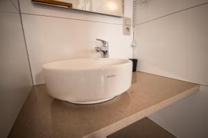 a white sink on a counter in a bathroom at Schmiede Hotel in Schoenberg