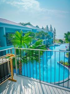 a balcony with a view of a swimming pool at HATCHAO HERITAGE BEACH FRONT RESORT in Ban Hat Cha Samran
