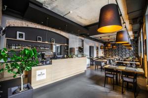 a restaurant with tables and chairs and a bar at Qbatura Cafe & Hotel in Ciechanów