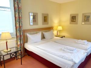 Postel nebo postele na pokoji v ubytování Appartements am Rondell Neddesitz, Appartement 306