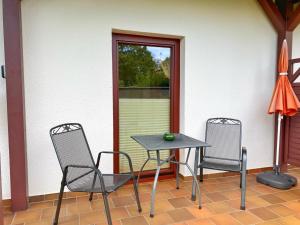 a table and two chairs on a patio at Ferienwohnungen Stadtmitte - Fewo 2 in Sassnitz +10 photos