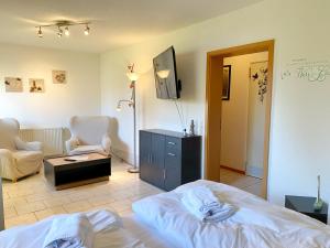 a bedroom with a bed and a living room at Ferienwohnungen Stadtmitte - Fewo 2 in Sassnitz