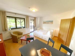 een woonkamer met een bed en een tafel en stoelen bij Landpension Dubnitz Landpension Dubnitz - Ferienwohnung 4 