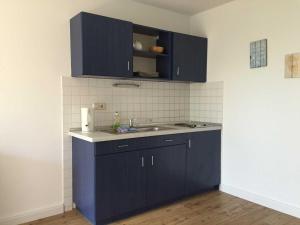 una cocina con armarios azules y fregadero en Landpension Dubnitz Landpension Dubnitz - Ferienwohnung 7, 