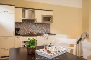 eine Küche mit einem Tisch und einem Tablett mit Essen darauf in der Unterkunft Lietzow Appartementhaus Möwe Haus Möwe - Ferienwohnung 2 "Fischmöwe" in Lietzow + 21 Fotos