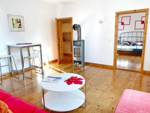 a living room with a couch and a table at Sassnitz - Seaside Appartements Seaside Appartements, "Red" in Sassnitz