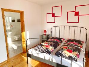 a bedroom with a bed with red squares on the wall at Sassnitz - Seaside Appartements Seaside Appartements, "Red" in Sassnitz +2 photos