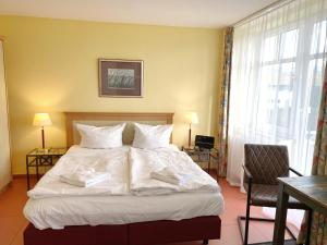 Giường trong phòng chung tại Appartements am Rondell Neddesitz, Appartement 308 +1 ảnh