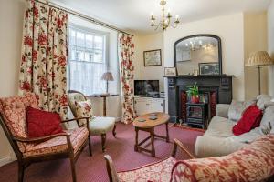 a living room with a couch and a fireplace at Rorkes Cottage in Brecon