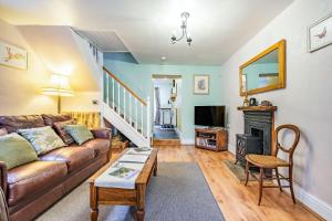 a living room with a couch and a fireplace at Wayside Cottage in Darlington