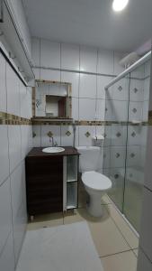 a bathroom with a toilet and a sink at Flats Atitude Maragogi centro in Maragogi +69 photos