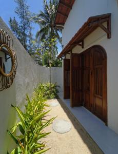 a entrance to a house with a wooden door at Nhà mình homestay in Mỹ Lại (1)