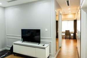 a living room with a flat screen tv on a white cabinet at Thiên Ân Hotel Bắc Giang in Bắc Giang