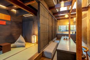 a japanese room with a bench and a window at Kyo no oozora KIHANA in Kyoto