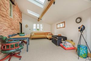 a living room with a couch and a table at Old Bridge Post Office in Watchet