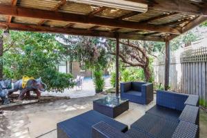 a patio with blue furniture under a pergola at Idyllic Ingram in Anglesea