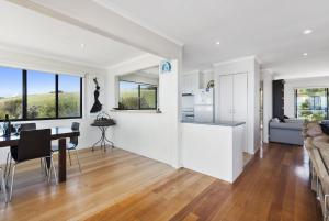 a kitchen and living room with a table and a couch at Il Mare The Ocean in Skenes Creek