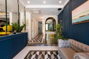 a hallway with blue walls and a couch at Louis Mo Apartment in Da Nang