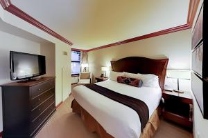 ein Hotelzimmer mit einem Bett und einem Flachbildfernseher in der Unterkunft Resort at Squaw Creek's 521 in Olympic Valley + 40 Fotos