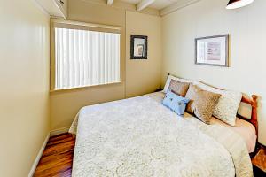 a bedroom with a large bed and a window at Sailaway Cabin A in Ventura