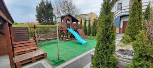 a playground with a slide in a yard at Willa Bryza Rewa in Rewa