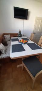a dining room table with blue and white mats at Apartma Dana-Brinjtesa in Jesenice