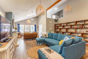 a living room with two blue couches and a kitchen at Fair Views in Sussex inlet