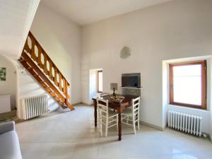 a dining room with a table and a television at Pleasant holiday home in Marone with balcony terrace in Marone