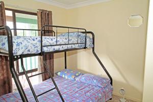 A bunk bed or bunk beds in a room at House that has the Lot