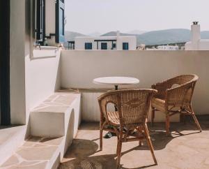 a table and two chairs and a table on a balcony at Perseas in Naousa