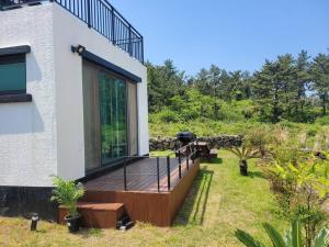 a deck on the side of a house at Saeville Stay in Jeju
